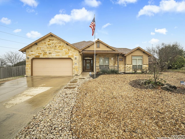 ranch-style house featuring a garage and covered porch