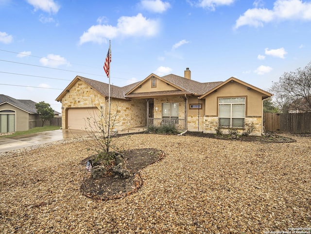 ranch-style home featuring a porch and a garage