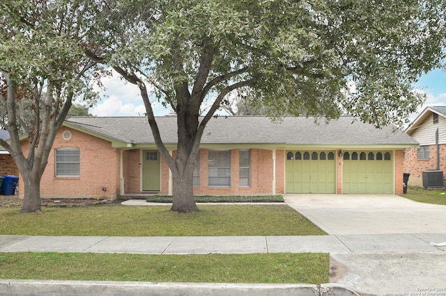 single story home featuring a garage, central AC unit, and a front yard