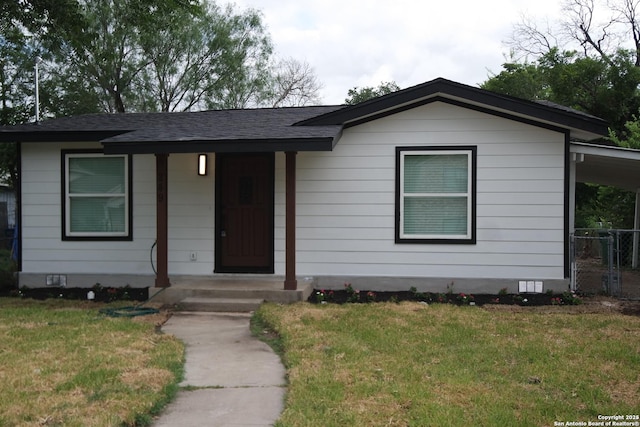 view of front of house with a front yard and a carport