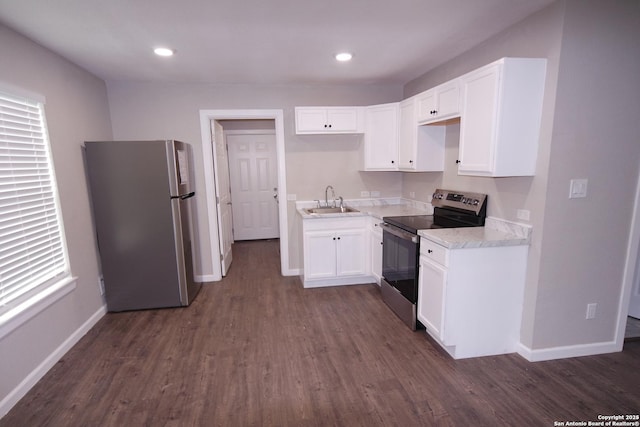 kitchen featuring white cabinetry, sink, dark wood-type flooring, and appliances with stainless steel finishes