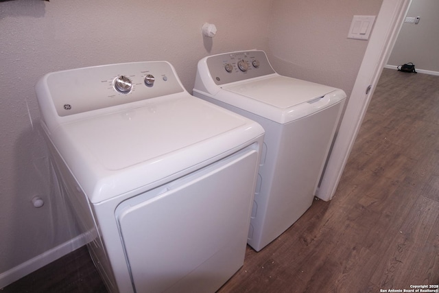 washroom featuring wood-type flooring and washer and clothes dryer