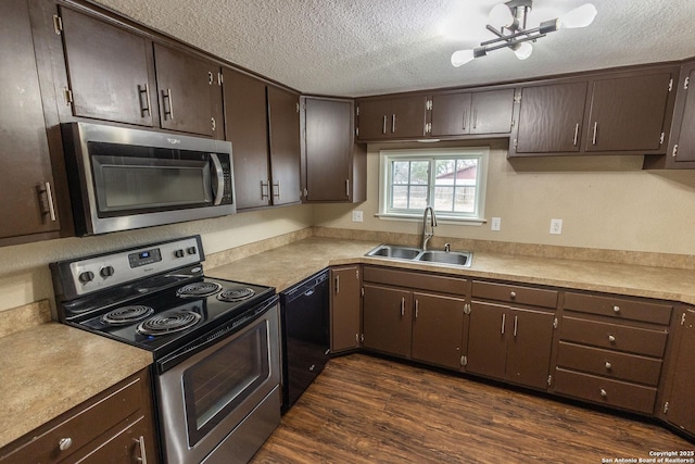 kitchen with dark brown cabinetry, appliances with stainless steel finishes, dark hardwood / wood-style flooring, and sink