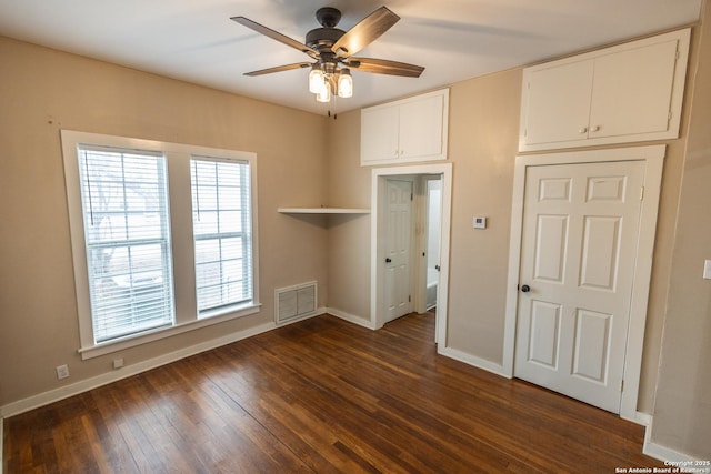 unfurnished room with ceiling fan and dark hardwood / wood-style flooring