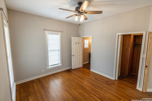 unfurnished bedroom with dark wood-type flooring and ceiling fan