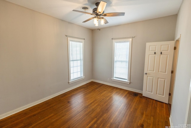 spare room featuring dark hardwood / wood-style floors and ceiling fan