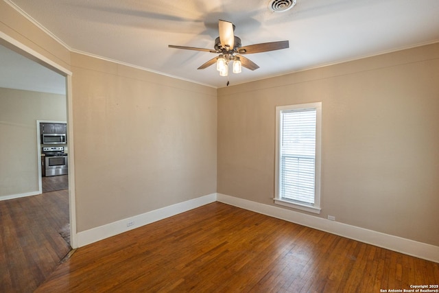 empty room featuring hardwood / wood-style flooring, ornamental molding, and ceiling fan