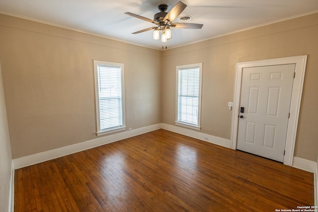 empty room featuring hardwood / wood-style flooring, ceiling fan, and crown molding