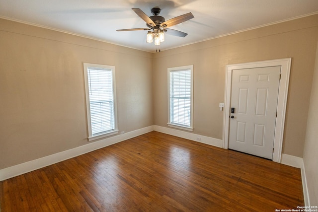 empty room with ceiling fan, ornamental molding, and dark hardwood / wood-style floors