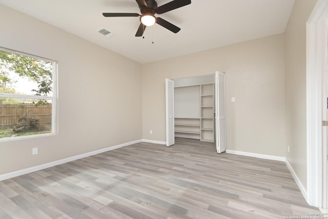 unfurnished bedroom with light hardwood / wood-style flooring, a closet, and ceiling fan