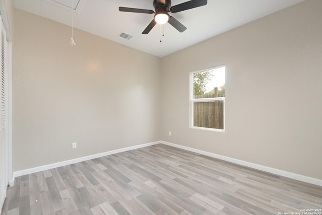 empty room with ceiling fan and light wood-type flooring