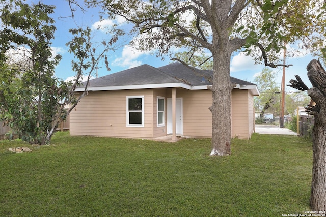 back of house with a yard