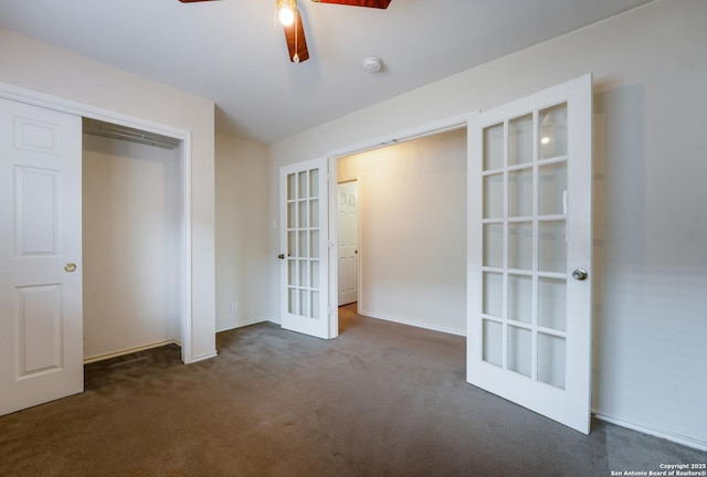 unfurnished bedroom featuring french doors, ceiling fan, a closet, and dark colored carpet