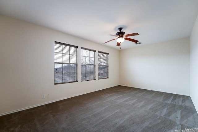 carpeted spare room with ceiling fan