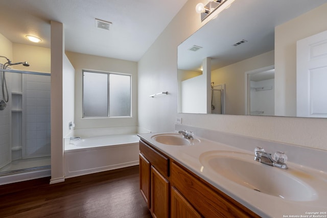 bathroom featuring vanity, hardwood / wood-style floors, and separate shower and tub