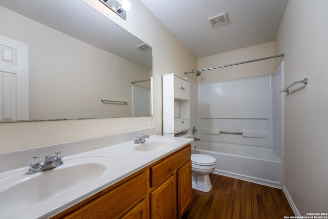 full bathroom featuring vanity, wood-type flooring, tub / shower combination, and toilet