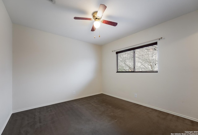 carpeted spare room featuring ceiling fan