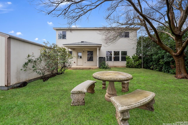 back of property featuring a patio area and a lawn