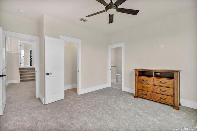 unfurnished bedroom featuring ceiling fan, connected bathroom, and light carpet