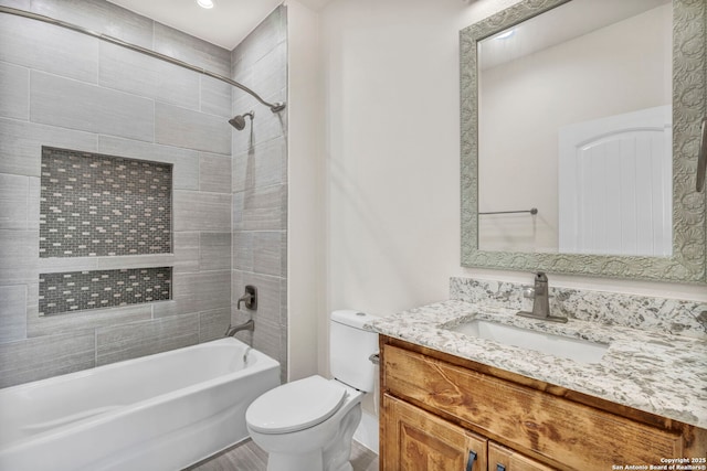 full bathroom with tiled shower / bath combo, vanity, and toilet