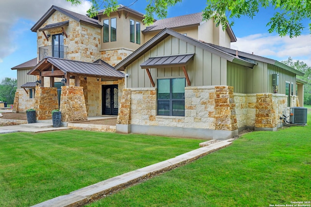 view of front facade with central AC unit and a front yard