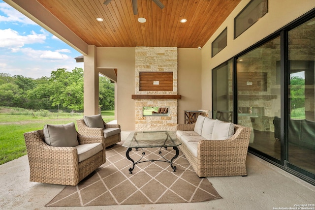 view of patio / terrace featuring an outdoor living space with a fireplace and ceiling fan