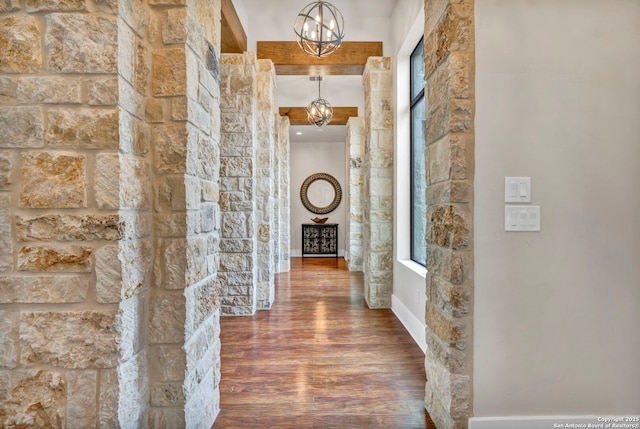 hall featuring hardwood / wood-style floors and a notable chandelier