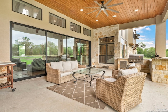 view of patio / terrace with an outdoor living space, an outdoor kitchen, a grill, and ceiling fan