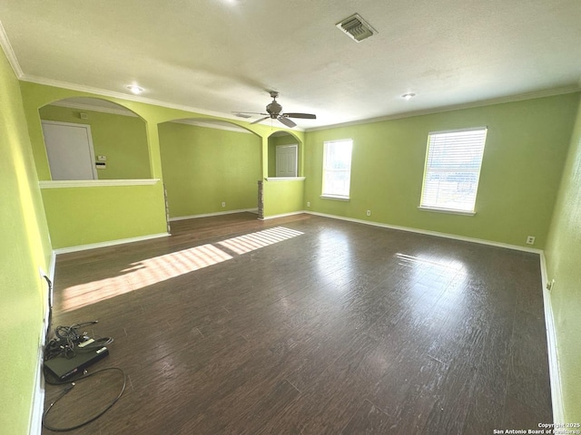 unfurnished room featuring dark hardwood / wood-style flooring, crown molding, and ceiling fan