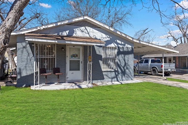 bungalow-style home with a carport, covered porch, and a front lawn