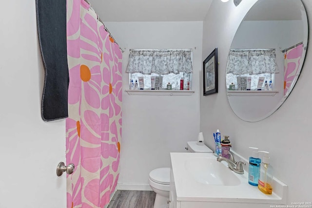 bathroom featuring vanity, toilet, and hardwood / wood-style floors