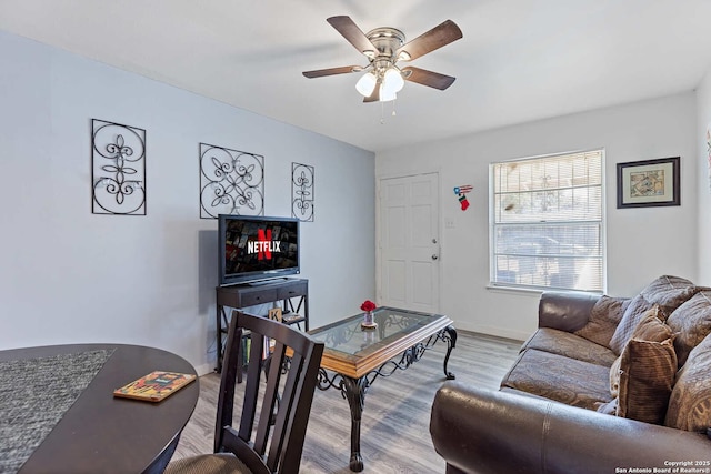 living room featuring ceiling fan and light hardwood / wood-style flooring