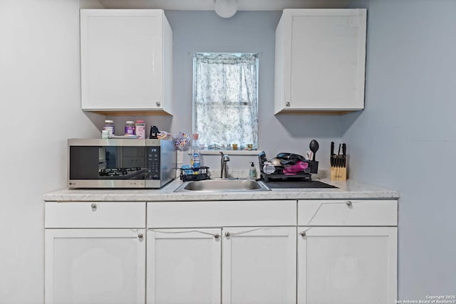 kitchen with sink and white cabinets