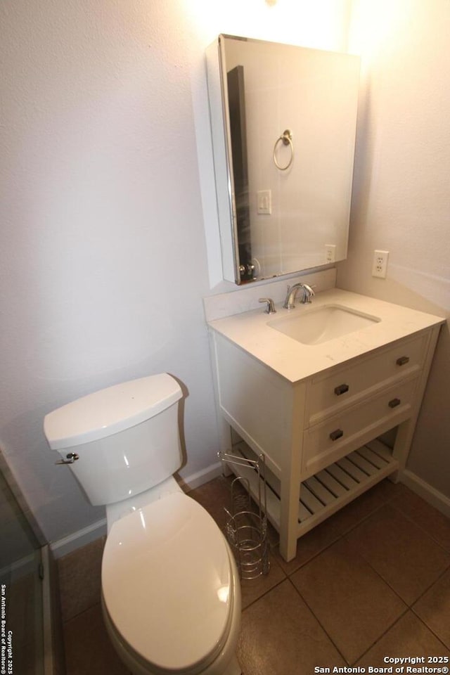 bathroom with vanity, toilet, and tile patterned flooring