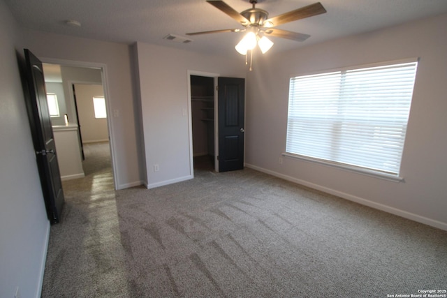 unfurnished bedroom with carpet flooring, ceiling fan, and a closet