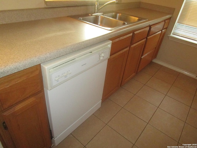 kitchen featuring sink, light tile patterned floors, and dishwasher