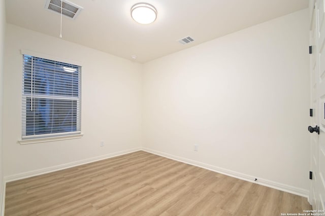 spare room with light hardwood / wood-style floors