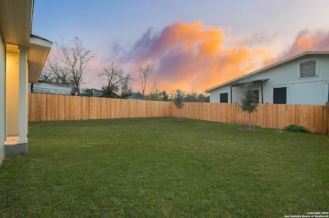 view of yard at dusk