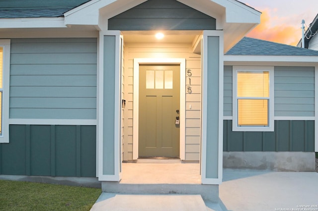 view of exterior entry at dusk