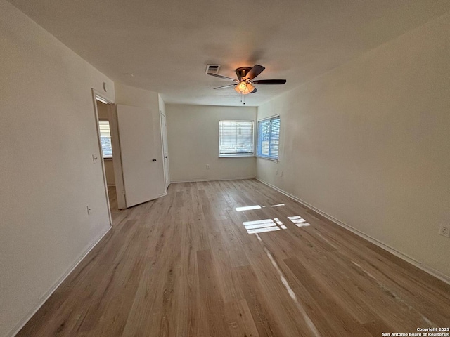 spare room featuring ceiling fan and light hardwood / wood-style flooring