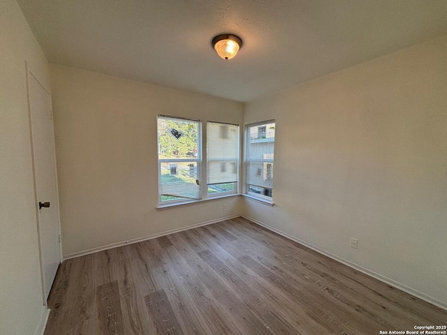 unfurnished room with light hardwood / wood-style flooring