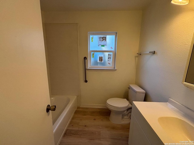 bathroom with vanity, hardwood / wood-style flooring, and toilet