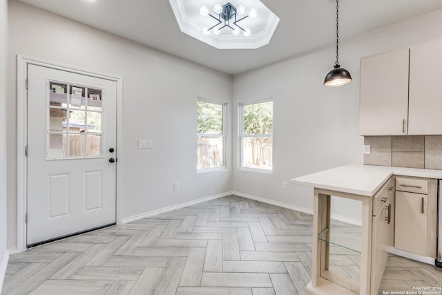 interior space with white cabinets, decorative backsplash, light parquet flooring, and decorative light fixtures