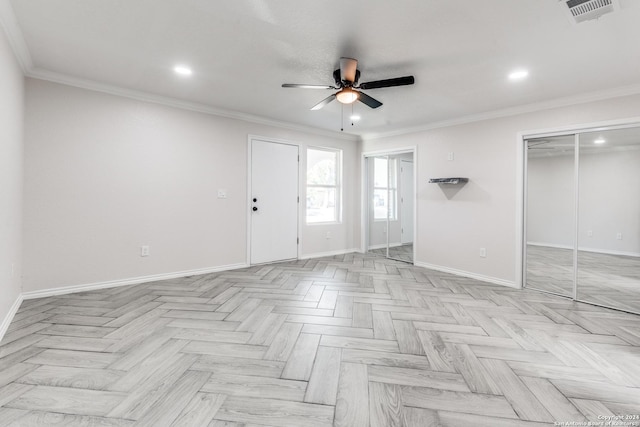 interior space with ornamental molding, ceiling fan, and light parquet flooring