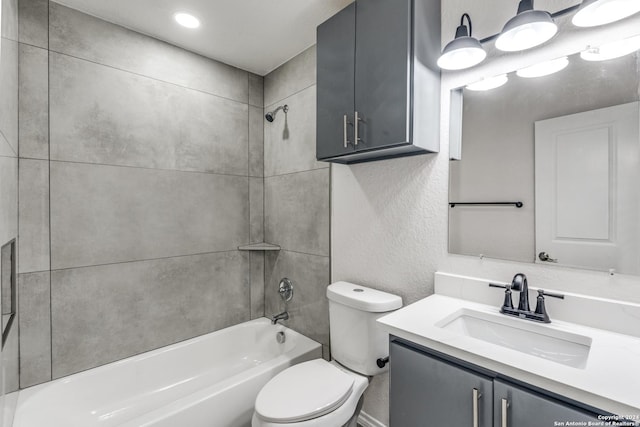 full bathroom featuring toilet, vanity, and tiled shower / bath combo