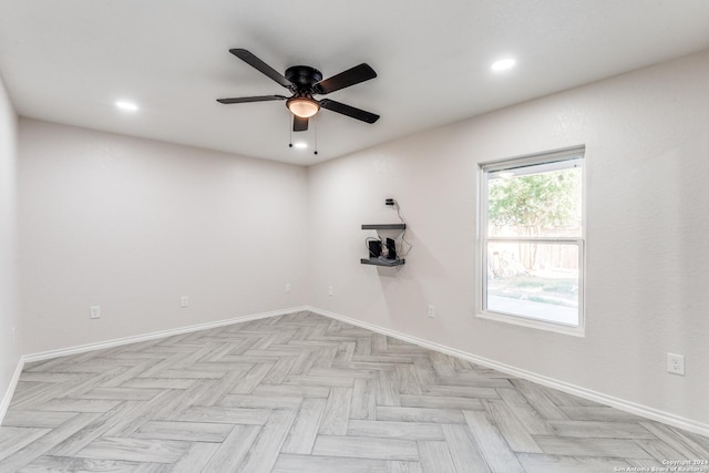 spare room featuring light parquet flooring and ceiling fan