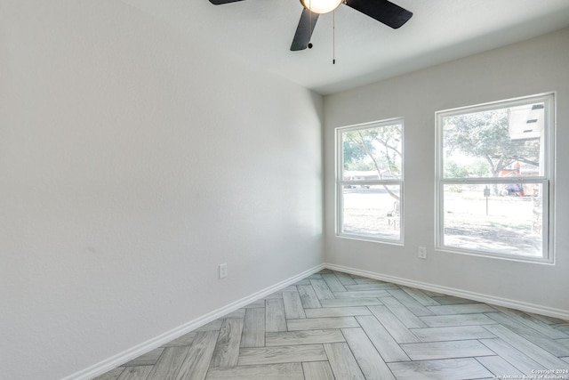 spare room with light parquet flooring and ceiling fan