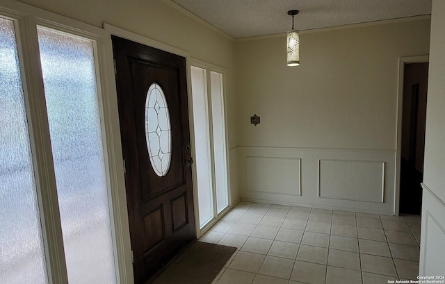 tiled foyer featuring a textured ceiling