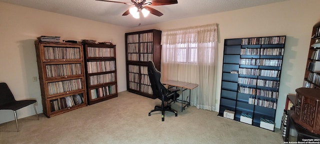 office area with ceiling fan, light carpet, and a textured ceiling