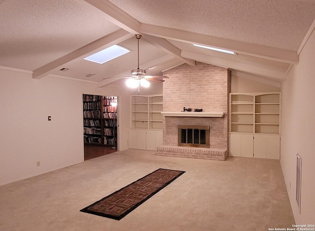 unfurnished living room featuring ceiling fan, a brick fireplace, carpet floors, and a textured ceiling